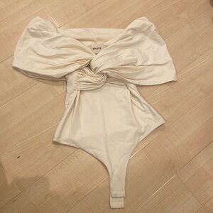 KHAITE - Brand New - 'Cerise' Off-The-Shoulder Knotted Jersey Bodysuit in Cream